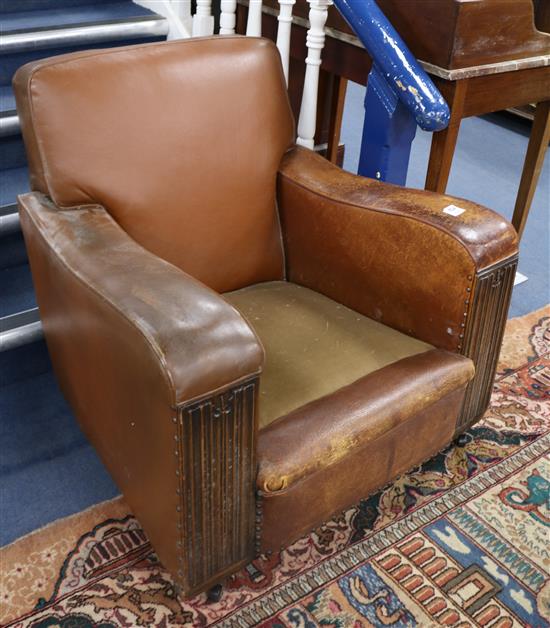 A 1930s tan leather and linenfold carved armchair and a 1940s French tan leather armchair